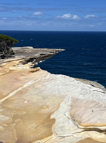 Home Rocky coastal cliff with layered sedimentary and solid rock formations representing EcoDream Climber's supportive and tailored career coaching services that help individuals grow professionally and confidently.